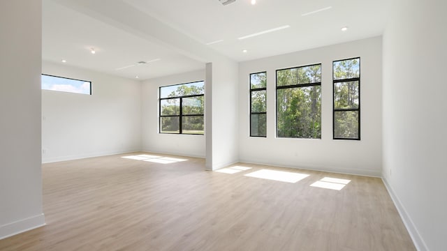 empty room with light hardwood / wood-style flooring