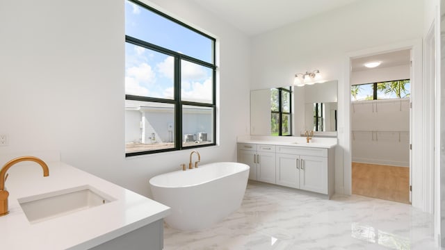 bathroom featuring vanity and a tub