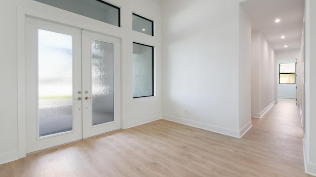 doorway to outside with french doors and light wood-type flooring