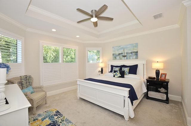 carpeted bedroom featuring ceiling fan, ornamental molding, and a raised ceiling