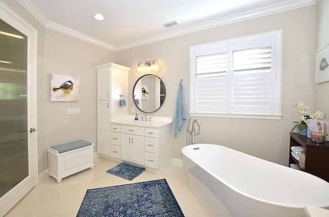 bathroom featuring vanity, a tub to relax in, crown molding, and tile patterned floors