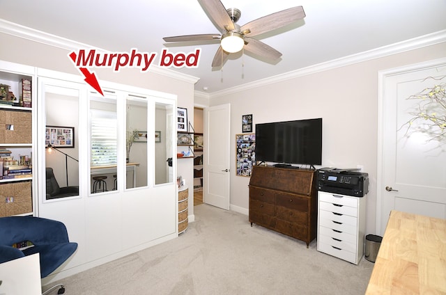 carpeted office featuring ornamental molding and ceiling fan