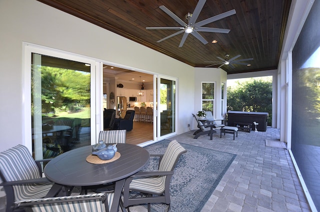 view of patio featuring ceiling fan and a hot tub