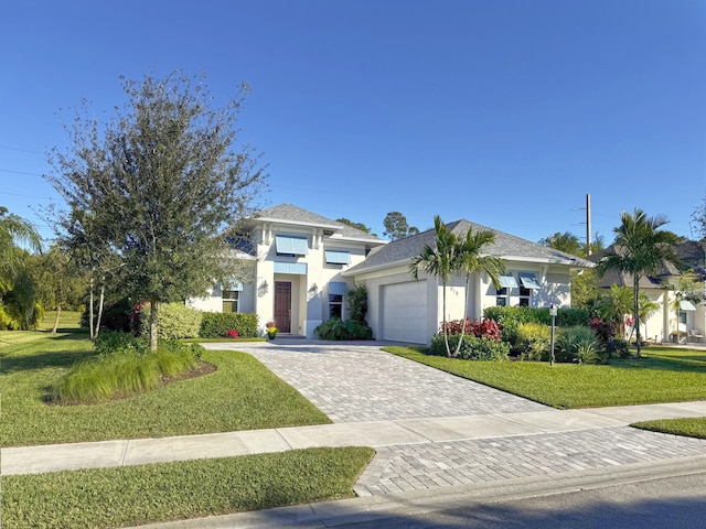 view of front of home featuring a garage and a front yard