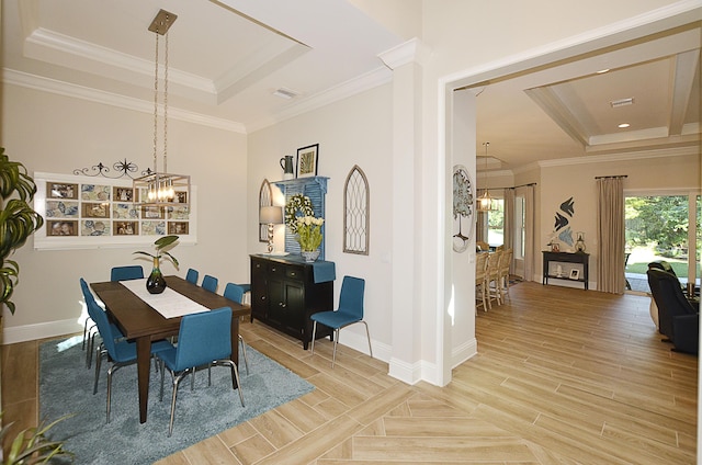 dining room with ornamental molding, a tray ceiling, light hardwood / wood-style flooring, and a notable chandelier