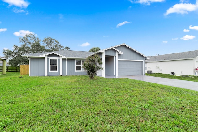 single story home featuring a garage and a front lawn