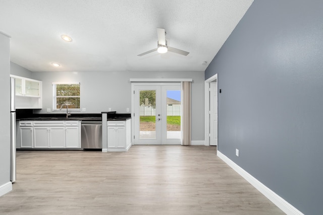 kitchen with sink, white cabinets, stainless steel dishwasher, french doors, and light wood-type flooring