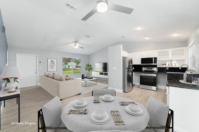 dining area with lofted ceiling, ceiling fan, and light hardwood / wood-style flooring