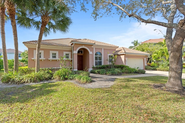 mediterranean / spanish-style house with a garage and a front yard