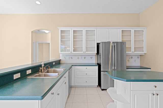 kitchen with white cabinetry, sink, stainless steel appliances, and light tile patterned flooring