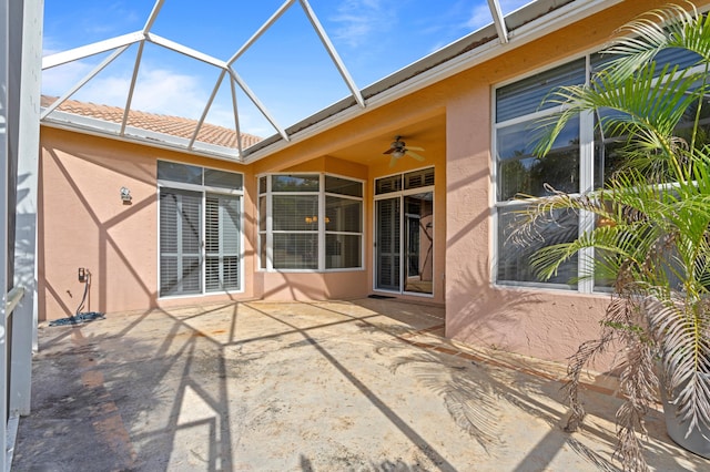 view of patio featuring a lanai and ceiling fan