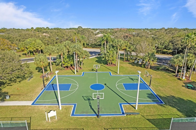 view of sport court featuring a yard