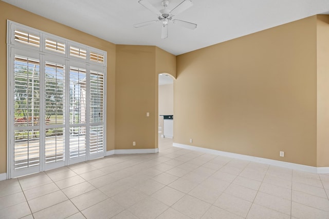 tiled spare room with ceiling fan