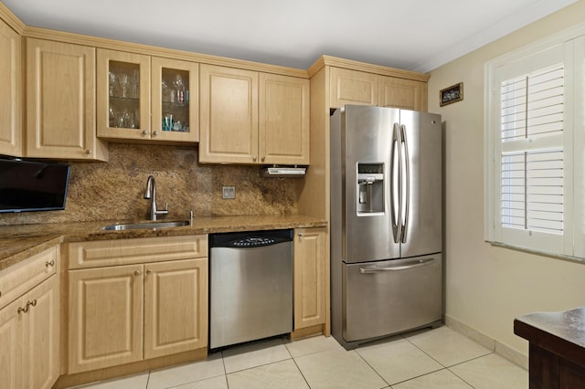 kitchen with sink, stone counters, stainless steel appliances, tasteful backsplash, and light brown cabinets