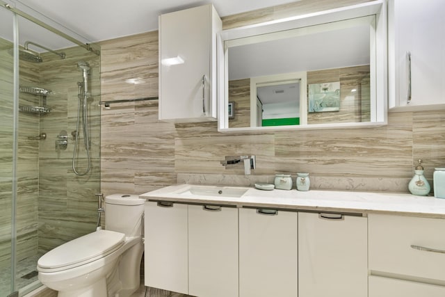 bathroom featuring tile walls, vanity, backsplash, and toilet