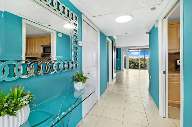 hall featuring light tile patterned flooring