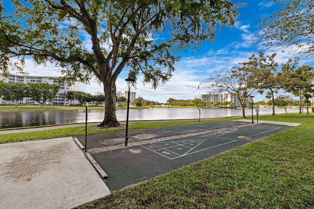 view of property's community featuring a water view and a yard