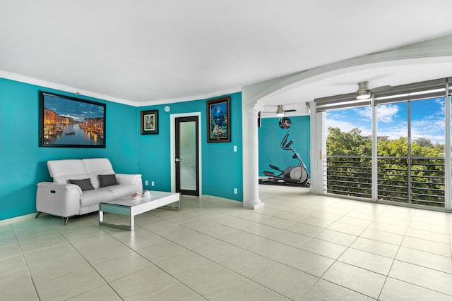 unfurnished living room featuring light tile patterned floors, ornamental molding, and ceiling fan