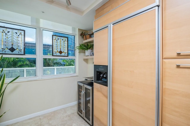 kitchen with light tile patterned floors, beverage cooler, and paneled built in fridge