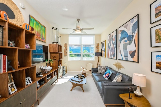 sitting room with light colored carpet and ceiling fan