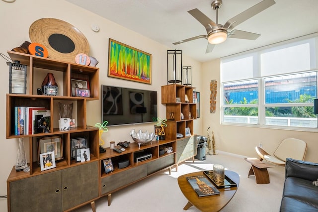 carpeted living room with ceiling fan