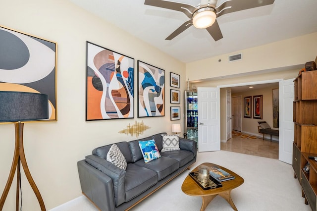 carpeted living room with ceiling fan