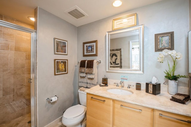 bathroom with vanity, toilet, and an enclosed shower