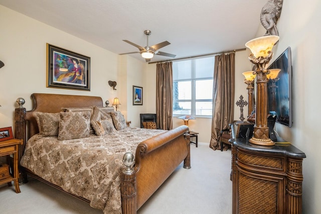 bedroom with ceiling fan and light carpet