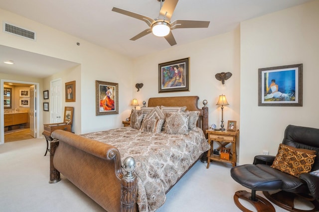 bedroom with light colored carpet and ensuite bathroom