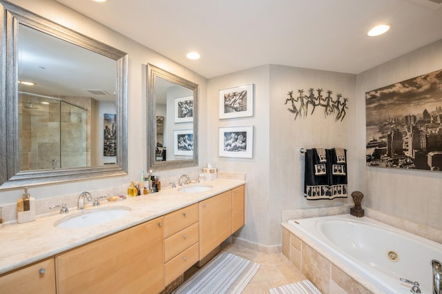 bathroom with tile patterned floors, vanity, and independent shower and bath