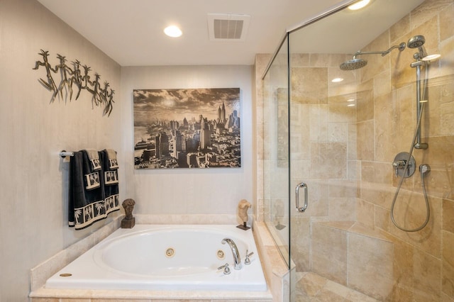 bathroom featuring shower with separate bathtub