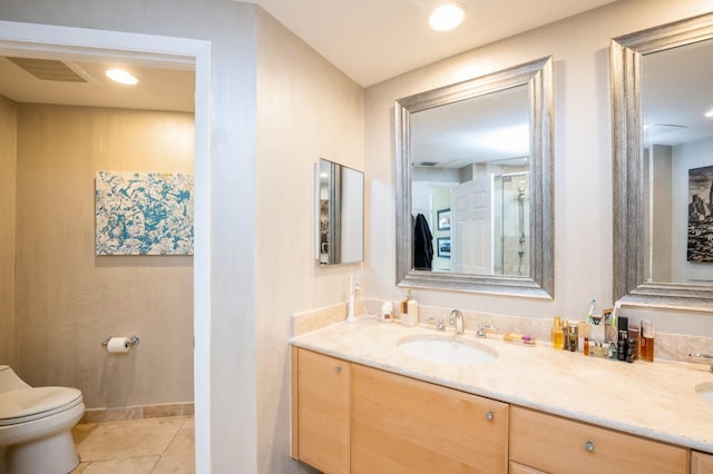 bathroom with vanity, tile patterned floors, and toilet