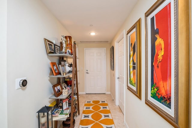 hall featuring light tile patterned floors