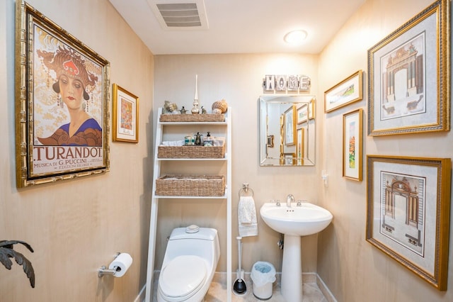 bathroom with toilet and sink