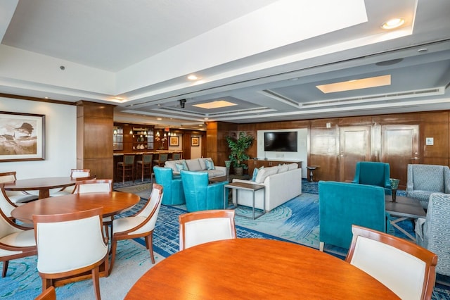 dining room with a tray ceiling and light hardwood / wood-style floors