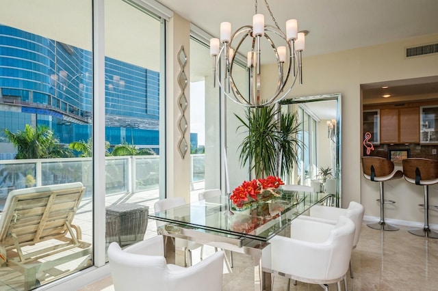 dining space with an inviting chandelier, floor to ceiling windows, and light tile patterned flooring