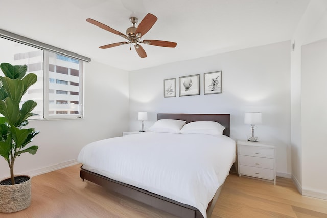 bedroom with ceiling fan and light hardwood / wood-style floors