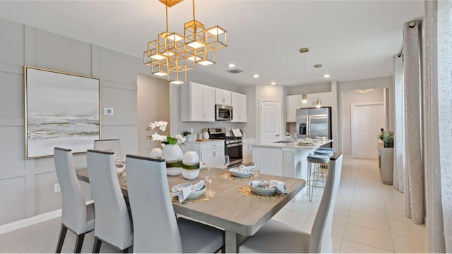 dining space featuring light tile patterned flooring and sink