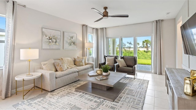 tiled living room featuring ceiling fan and a healthy amount of sunlight