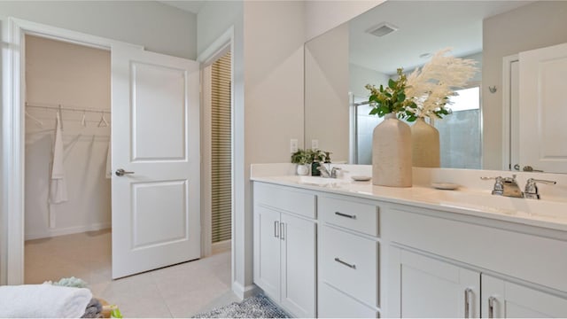 bathroom featuring tile patterned flooring and vanity