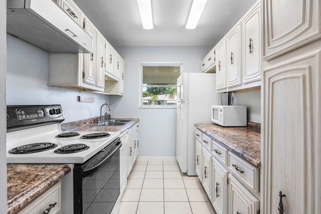 180 High Point Ter E Unit C, Delray Beach, FL 33445 - kitchen featuring range with electric cooktop, a sink, white microwave, under cabinet range hood, and light tile patterned floors