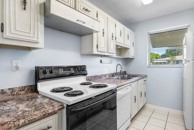 180 High Point Ter E Unit C, Delray Beach, FL 33445 - kitchen featuring white appliances, a sink, under cabinet range hood, light tile patterned floors, and white cabinetry