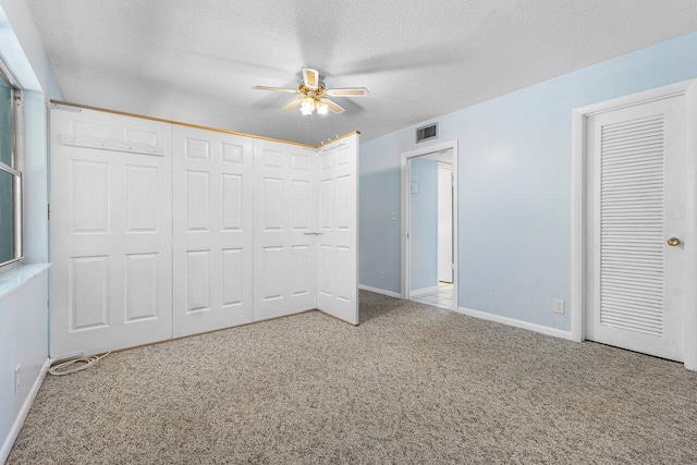 180 High Point Ter E Unit C, Delray Beach, FL 33445 - unfurnished bedroom with carpet, a textured ceiling, baseboards, and a ceiling fan