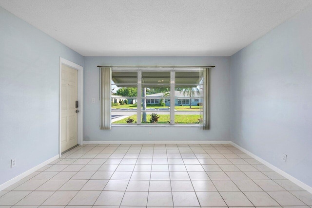 180 High Point Ter E Unit C, Delray Beach, FL 33445 - spare room with healthy amount of natural light, a textured ceiling, and baseboards