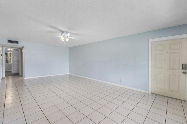 180 High Point Ter E Unit C, Delray Beach, FL 33445 - empty room with ceiling fan, a textured ceiling, baseboards, and light tile patterned flooring