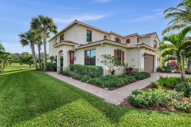 mediterranean / spanish-style house featuring a garage and a front yard