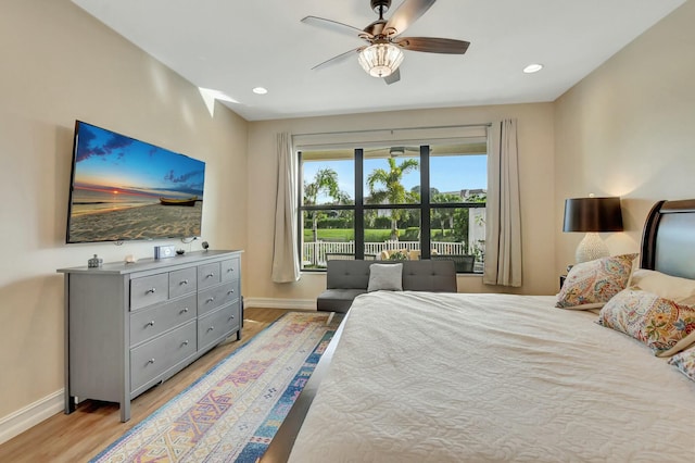 bedroom with ceiling fan and light hardwood / wood-style floors