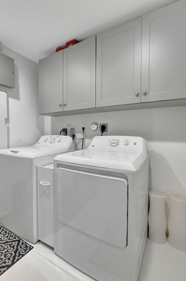 laundry area featuring cabinets and washing machine and clothes dryer