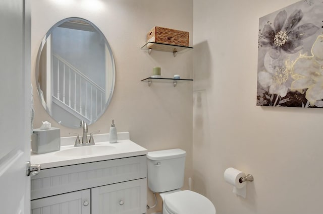 bathroom featuring vanity and toilet