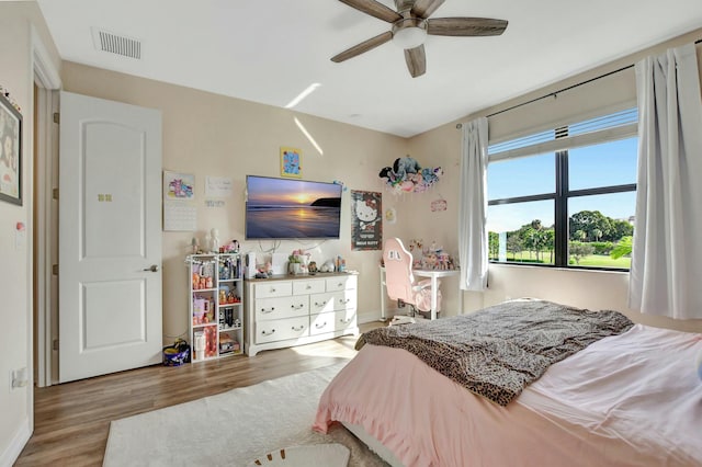 bedroom with ceiling fan and hardwood / wood-style floors